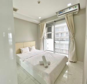 a bedroom with a bed and a large window at Scenic Valley Marvel in Ho Chi Minh City