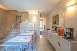 a kitchen with two sinks and a staircase at B&B Il Piccolo Paradiso in San Felice del Benaco