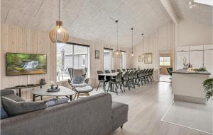 a living room with a couch and a table and chairs at Beautiful Home In Idestrup With Sauna in Marielyst