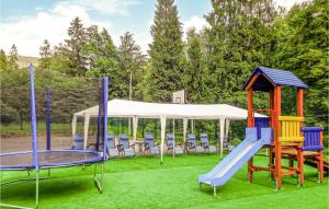 a playground with slides and chairs in a tent at 1 Bedroom Amazing Apartment In Ustron in Ustroń