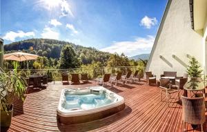 a hot tub on a deck with a view of a mountain at 1 Bedroom Amazing Apartment In Ustron in Ustroń