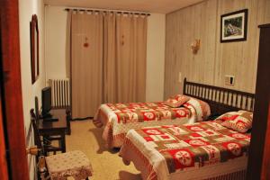 Ένα ή περισσότερα κρεβάτια σε δωμάτιο στο Hotel Garona