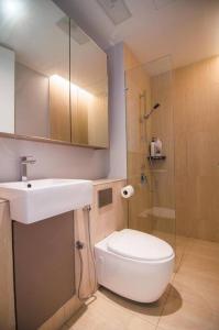 a bathroom with a toilet and a sink and a shower at Lumi Tropicana - Idealhub in Petaling Jaya +54 photos
