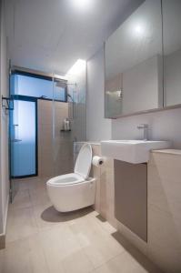 a bathroom with a toilet and a sink at Lumi Tropicana - Idealhub in Petaling Jaya