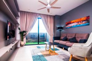 a living room with a couch and a large window at Lumi Tropicana - Idealhub in Petaling Jaya