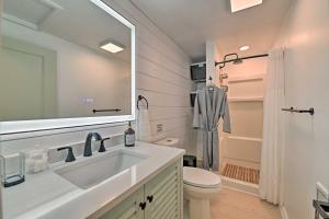 a bathroom with a sink and a toilet and a mirror at Modern Apartment Near Hiking and Race Course in Saratoga Springs +19 photos