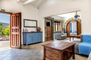 a living room with a blue couch and a table at Porto Koufo Resort in Porto Koufo