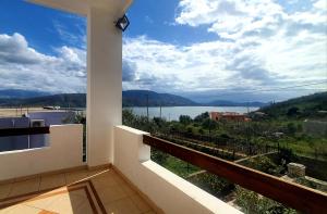 a balcony with a view of a body of water at Mihal Suites in Sarandë