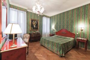 a bedroom with a bed and green wallpaper at Palazzo Cendon Piano Antico in Venice