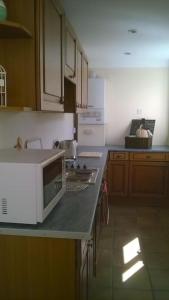 a kitchen with a white microwave on a counter at Large countryside home in Tow Law +52 photos