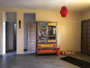 a dog laying on the floor in a room with a cabinet at Chambres vue imprenable in Guéréo