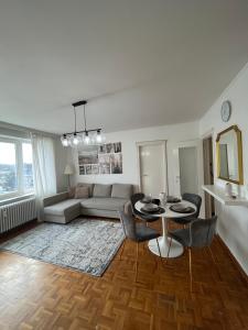a living room with a table and a couch at Amajed in Namur