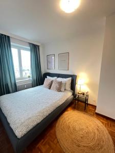 a bedroom with a bed and a large window at Amajed in Namur