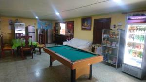 a living room with a pool table and a refrigerator at Guest-House alquiler in Santo Domingo