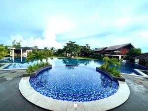 a large pool with blue water in a resort at Vistapaloma beach resort in Odiong