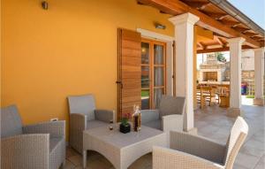a patio with a table and chairs on a porch at 3 Bedroom Cozy Home In Hr-52215 Vodnjan in Vodnjan