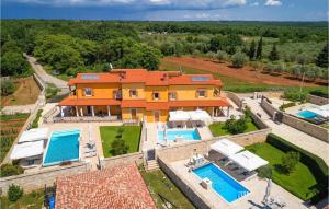 an aerial view of a house with two swimming pools at 3 Bedroom Cozy Home In Hr-52215 Vodnjan in Vodnjan