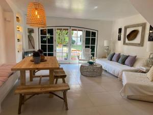 a living room with a couch and a table at T3 Townhouse Old Village Vilamoura in Vilamoura