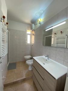 een badkamer met een wastafel en een toilet bij Luci in San Vincenzo +20 foto's
