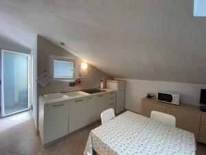a kitchen with a table and a sink and a table and chairs at Luci in San Vincenzo