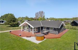 a large house with a large deck and a yard at 3 Bedroom Lovely Home In Jgerspris in Jægerspris