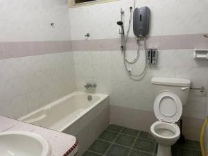 a bathroom with a shower and a toilet and a sink at Greenlane 4-bedroom landed home (12 pax) in Gelugor