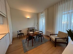 a living room with a table and a chair and a couch at bnapartments Cedofeita in Porto