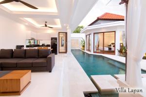 a living room and kitchen with a swimming pool in a house at Villa Mia Seminyak - Boutique Villas in Seminyak