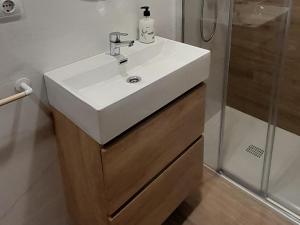 a bathroom with a white sink and a shower at Apartamento Ayuntamiento in Logroño