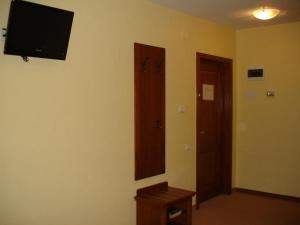 a room with a flat screen tv on a wall at Hotel Lucy Star in Cluj-Napoca