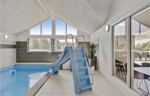 a indoor swimming pool with a slide in a house at Lovely Home In Spttrup With Sauna in Lem