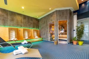 a room with a swimming pool and a person in the background at Hotel Seehof Haltern am See in Haltern