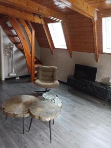 a room with a chair and a table and a tv at Bungalow Sud-Harz Bleicherode onder in Bleicherode