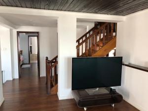 a television in a living room with a staircase at TopVila in Comarnic