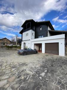 a car parked in front of a house at TopVila in Comarnic