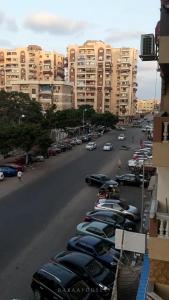 a row of cars parked in a parking lot with buildings at شقة مميزة في وسط بورسعيد 