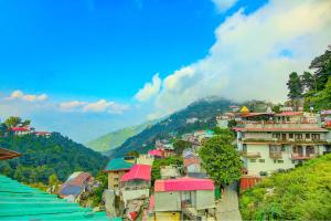 a group of buildings on a hill with a town at FabHotel Dwaper in Mussoorie