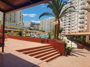 a resort with a palm tree and some buildings at CPR SolNascente in Portimão