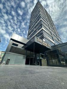 a tall building with a sign in front of it at The Kailyn Hotels&Suites Ataşehir in Istanbul