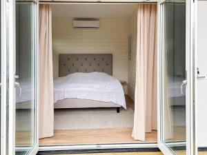 a bedroom with a bed through a glass door at 4 person holiday home in FARHULT-By Traum in Farhult
