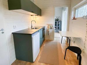 a kitchen with a sink and a table at 4 person holiday home in FARHULT-By Traum in Farhult