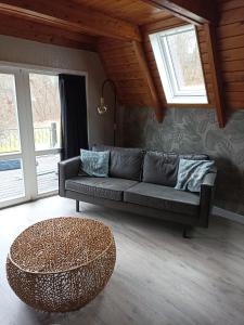 a living room with a couch and a coffee table at Bungalow Sud-Harz Bleicherode - boven in Bleicherode