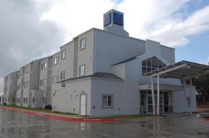 a large building with a clock tower on top of it at Motel 6-Cedar Park, TX in Cedar Park