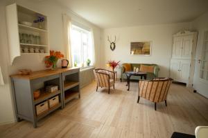 a living room with a table and chairs at Mosters Bed & Breakfast in Guldborg