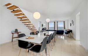 un comedor con mesa y sillas y una escalera en 5 Bedroom Amazing Home In Torrig L, en Kragenæs