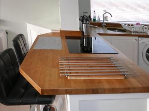 a kitchen with a wooden counter top and a sink at The Tides in Cleethorpes