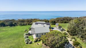 an aerial view of a house with the ocean in the background at The Hamptons at Marengo in Marengo