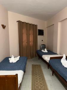 Postel nebo postele na pokoji v ubytování Anglo Hotel