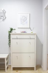 a white dresser with a picture on top of it at Villa Infante in Huelva