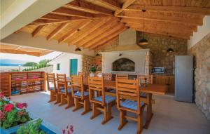 a kitchen and dining room with a table and a fireplace at Lovely Home In Glavina Donja With Wifi in Donja Glavina